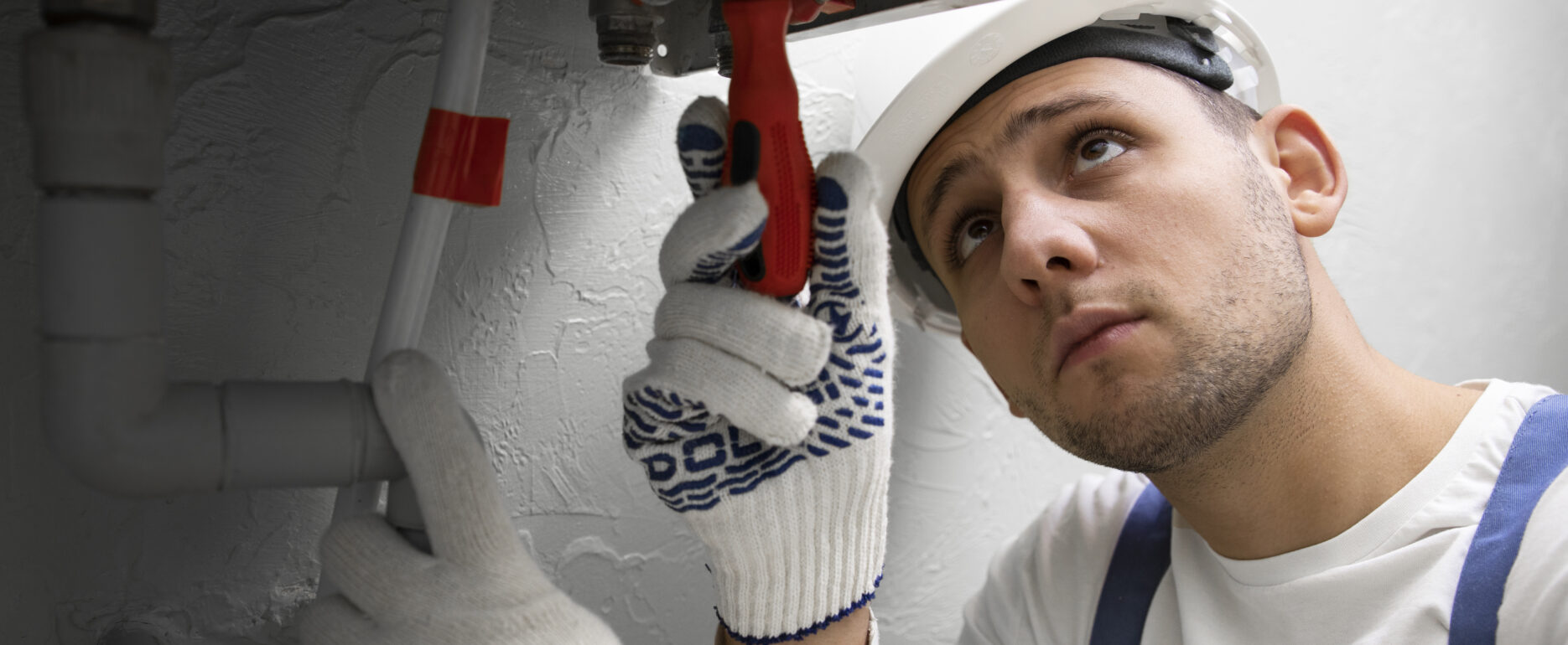 Tradesperson repairing a boiler