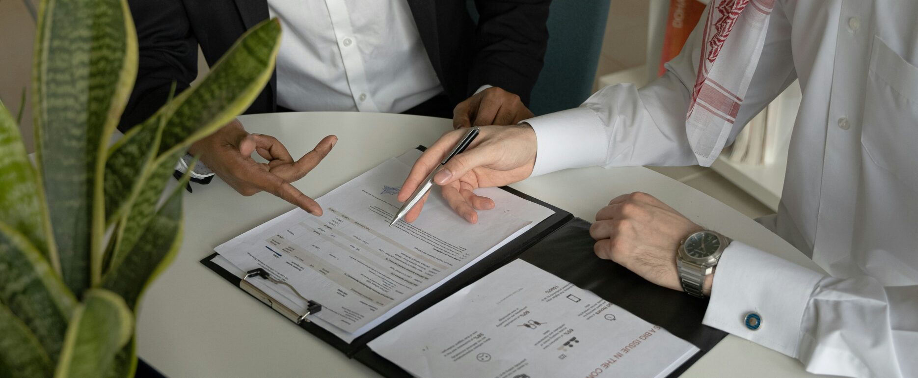 Business owner reviewing tax and pension paperwork at desk