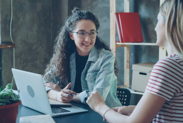 Three-generation family discussing succession planning in a home office setting
